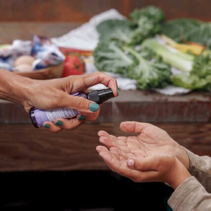 Dr. Bronner's Lavender Hand Sanitiser being sprayed on hands