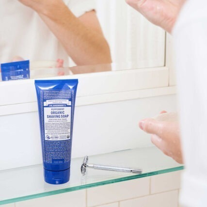 Dr. Bronner's organic shaving soap peppermint on bathroom shelf