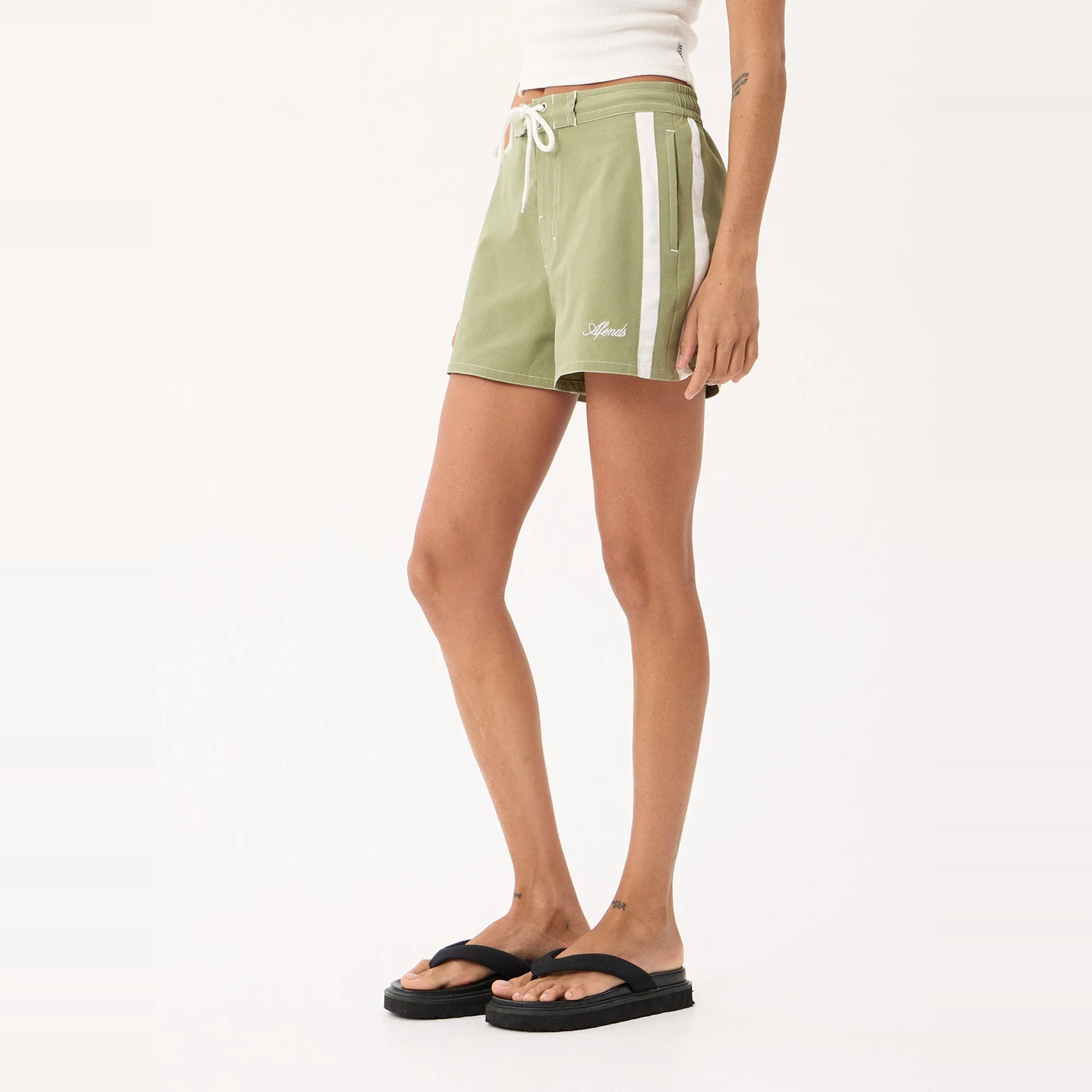 Afends Ellia Boardshorts in Sage, three-quarter view showing the white contrast side panel