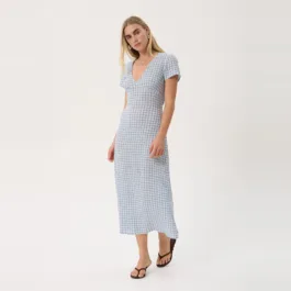 Model in the Afends Maeve Seersucker Maxi Dress in Powder Blue Check, three-quarter view showing the deep V-neck and short sleeves